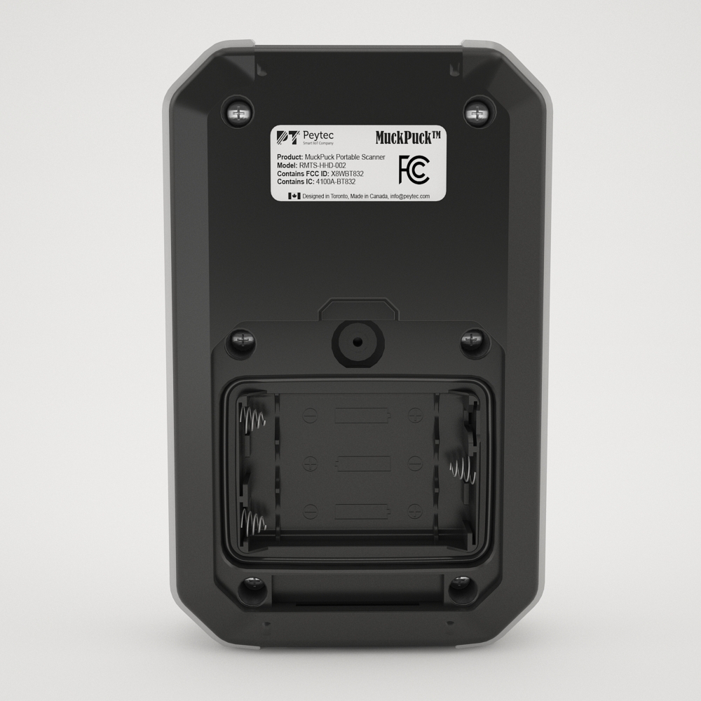 Rear of the MuckPuck Portable Scanner with the battery compartment open, showing three AA battery slots.